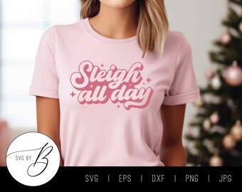 May include: Pink t-shirt with the text "Sleigh all day" in a retro font.