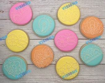 May include: Ten decorated sugar cookies with various intricate designs in shades of pink, yellow, blue, and orange. The cookies feature floral, paisley, and geometric patterns.