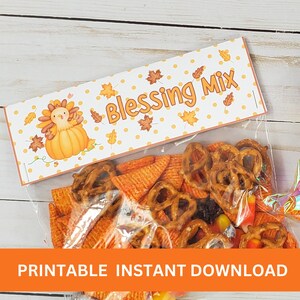 May include: Printable Thanksgiving treat bag label with a cute cartoon turkey holding a pumpkin. The label says "Blessing Mix" and has a white background with orange and brown accents.