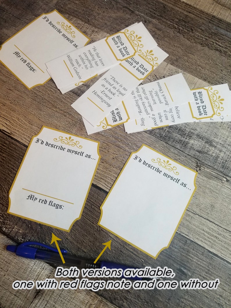 May include: Two blank cards with gold trim and the text "I'd describe myself as..." and "My red flags:"  The cards are on a wooden surface.  There are other cards with gold trim and text on the surface.  The text on the cards includes quotes about books and reading.
