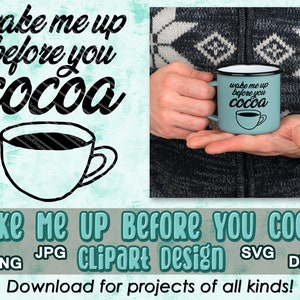 May include: A blue enamel mug with a black outline and the text "Wake me up before you cocoa" in black. The mug is being held by a hand wearing a brown and white sweater.