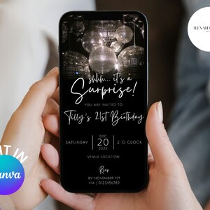 May include: A smartphone displays a black invitation for Tilly's 21st birthday, featuring the text "shhh... it's a Surprise!" and event details. The design includes disco balls and the Canva logo. The phone is held in two hands.