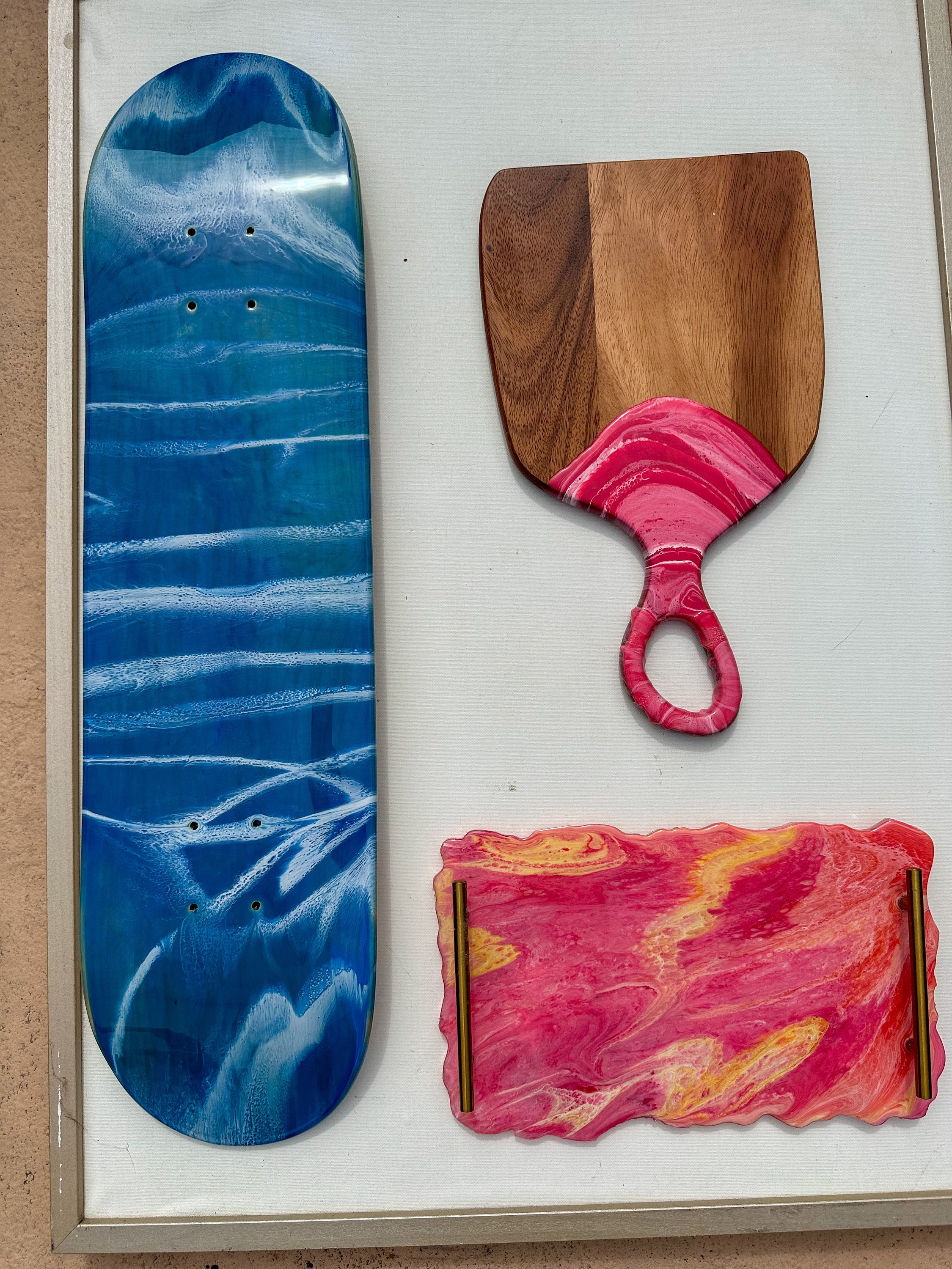 Resin skateboard deck wall art with ocean theme displayed as hanging shelf