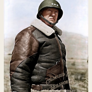 May include: Colorized image of a man in a military uniform. He wears a green helmet with three stars, a brown leather bomber jacket with a white fur collar, and a black belt. The image includes text that reads "COLORIZED BY HEILSHORN STUDIO" and "VICTORIA HEILSHORN COPYRIGHT 2021".