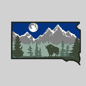 May include: A silhouette of a bison standing in front of a mountain range with a full moon in the sky. The mountains are covered in snow and the sky is blue. The image is in the shape of the state of South Dakota.
