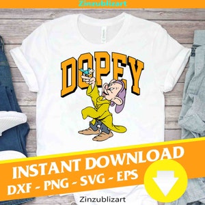 May include: A white t-shirt with a yellow and orange graphic of Dopey from Snow White and the Seven Dwarfs. Dopey is holding a blue bird in his hand. The text "DOPEY" is in yellow and orange letters. The text "INSTANT DOWNLOAD" is in black letters. The text "DXF - PNG - SVG - EPS" is in black letters. A yellow arrow pointing down is in the bottom right corner of the image.