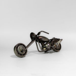 Handmade metal motorcycle sculpture made from recycled items and scrap metal.