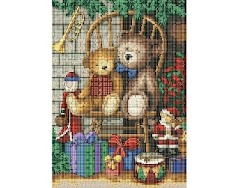 May include: Two teddy bears sit in a wooden rocking chair with a red bow tie on the larger bear. A small toy drummer sits in front of the chair with a red and white drum. There are wrapped presents in green, blue, and red with a red bow on one of the presents. The bears and toys are surrounded by green Christmas greenery.