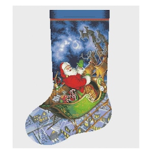May include: A Christmas stocking with a blue background featuring Santa Claus flying in his sleigh with reindeer over a snowy town. The stocking is filled with presents and candy canes.