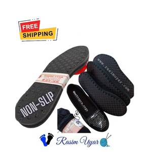 May include: Black non-slip shoe insoles with a textured surface and the words "NON-SLIP" printed on them. The insoles are next to a pair of black knitted shoes with a sparkly toe.