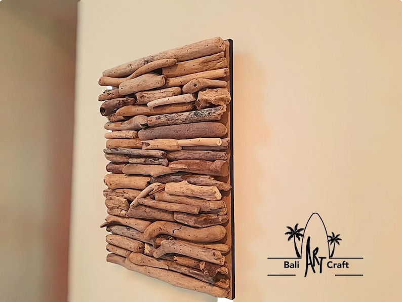 May include: A square wall art piece made of driftwood arranged in a layered pattern. The driftwood is a variety of shades of brown and beige. The piece is mounted on a black background.