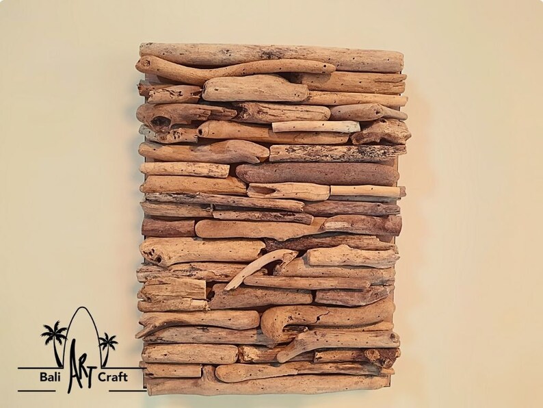 May include: A wall art piece made of driftwood arranged in a layered pattern. The driftwood is a natural light brown color and has a rustic, weathered look.