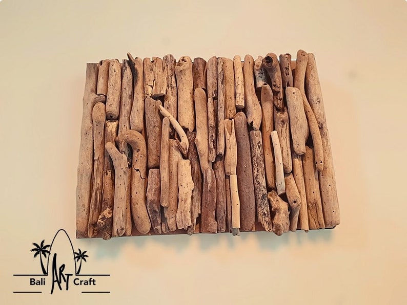 May include: A wall art piece made of driftwood arranged in a rectangular pattern. The driftwood is various shades of brown and beige.