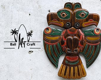 Hand-Carved Wooden Thunderbird Wall Art: Rustic Tribal Decor with Green, Red, Yellow Accents