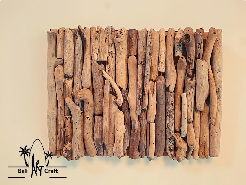 May include: A wall art piece made of driftwood arranged in a vertical pattern. The driftwood is a variety of shades of brown and beige. The piece is mounted on a wooden backing.