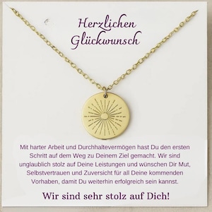 May include: A gold necklace with a round pendant featuring a sunburst design. The card reads "Herzlichen Gl&uuml;ckwunsch" and includes a message of congratulations and encouragement.