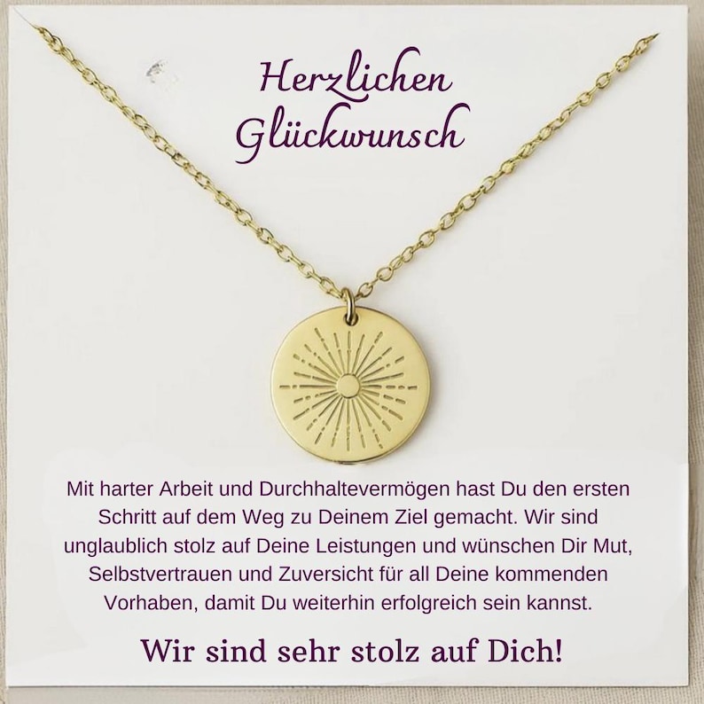 May include: A gold necklace with a round pendant featuring a sunburst design. The card reads "Herzlichen Gl&uuml;ckwunsch" and includes a message of congratulations and encouragement.
