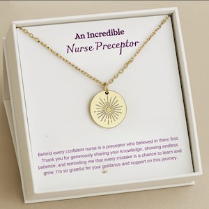 May include: A gold necklace with a round pendant featuring a sunburst design. The necklace comes in a white box with the text "An Incredible Nurse Preceptor" and a message of appreciation for a nurse mentor.
