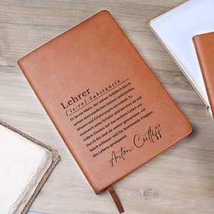May include: A brown leather journal with the word "Lehrer" defined as a noun in German. The definition is engraved on the front cover. The name "Anton Cuttiff" is also engraved on the cover.