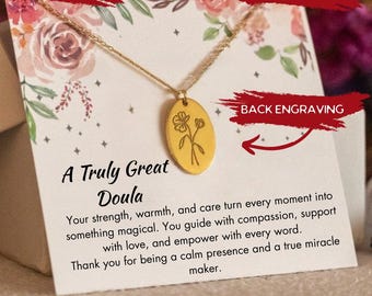 May include: Gold-colored oval pendant necklace with a floral design. The pendant hangs on a delicate chain. The card behind the necklace reads "A Truly Great Doula" with a message of appreciation. The image also includes the words "Fast Shipping", "Personalized", and "Back Engraving".