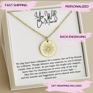 May include: Gold-colored necklace with a circular pendant featuring a sunburst design. The necklace is presented in a white gift box with text that reads "You Will Be Missed". The box also includes a message.
