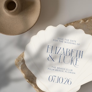 May include: Save the date for the wedding of Elizabeth & Luke at The Beach Club, Palm Beach, Florida on 07.10.26. The invitation is shaped like a seashell.