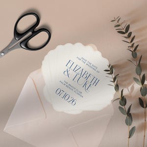 May include: Save the date card shaped like a seashell with the text "Save the date for the wedding of Elizabeth & Luke The Beach Club Palm Beach Florida 07.10.26"