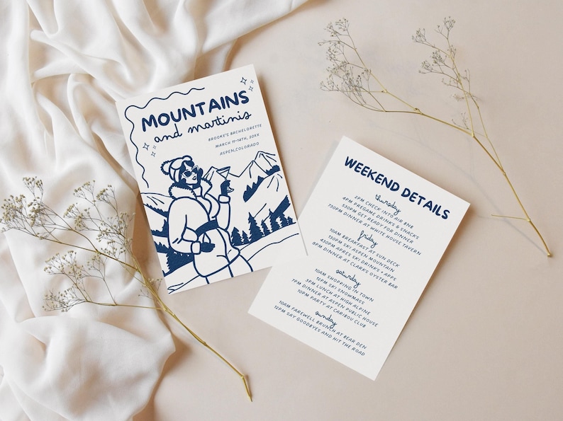 May include: A white invitation card with blue text and a graphic of a woman in a winter coat holding a martini glass. The text reads "Mountains and martinis" and "Brooke's Bachelorette March 9-11th, 2023 Aspen, Colorado". A second white card with blue text lists the weekend details for the event.