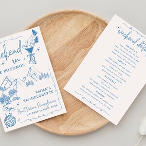 May include: A blue and white illustrated invitation for a bachelorette weekend in the Poconos. The invitation features a mountain landscape, a martini glass, and a disco ball. The text reads "Weekend in the Poconos, Emma's Bachelorette, Mount Pocono, Pennsylvania, October 11-14th, 20XX". The back of the invitation lists the weekend details for each day.