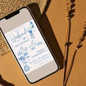 May include: A blue and white illustrated invitation for a bachelorette party weekend in the Poconos. The invitation features a mountain landscape, a cocktail glass, and a disco ball. The text reads "Weekend in the Poconos, Emma's Bachelorette, Mount Pacana, Pennsylfania, October 11-14th, 20XX".