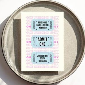 May include: Three blue and white ticket-style cards with pink text. The top card says "Madison's Bachelorette Weekend". The middle card says "Admit One". The bottom card says "Charleston, South Carolina".