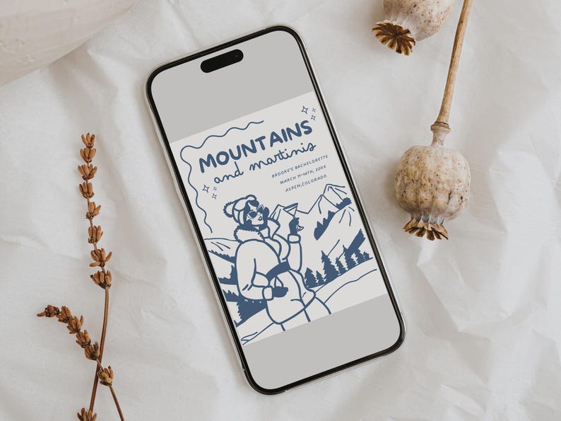May include: A phone screen displaying a blue and white illustration of a woman in a winter coat holding a martini glass. The text reads "MOUNTAINS and martinis" and "Brooke's Bachelorette March Ninth, 2023 Breckenridge, Colorado".