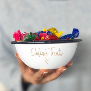 May include: White enamel bowl with a navy blue rim, filled with colourful wrapped sweets. The bowl has the text "Sofia's Treats" and a heart symbol in gold lettering.