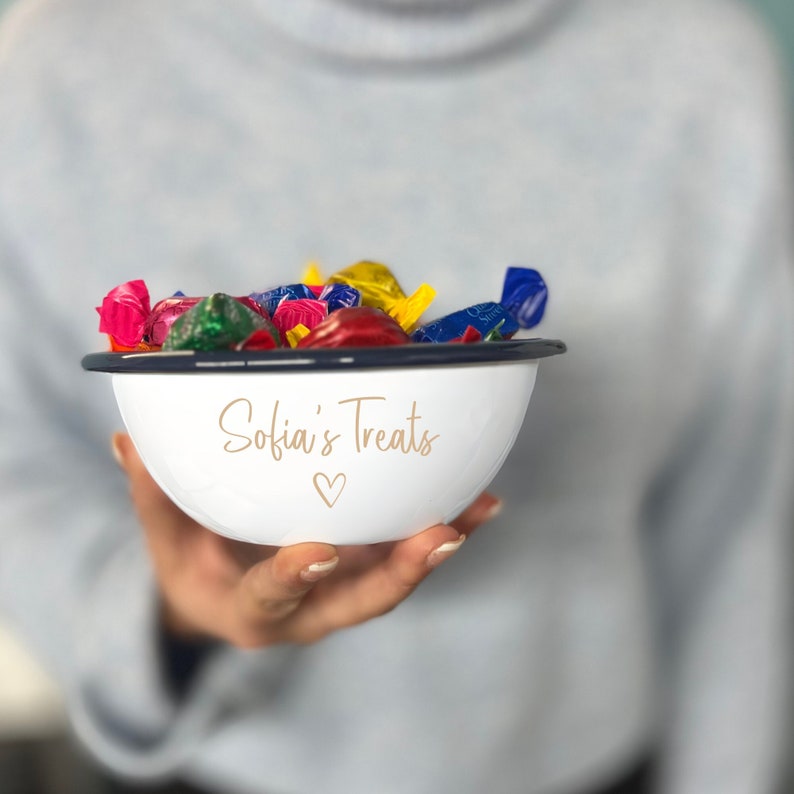 May include: White enamel bowl with a navy blue rim, filled with colourful wrapped sweets. The bowl has the text "Sofia's Treats" and a heart symbol in gold lettering.
