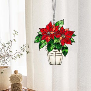 Roter Weihnachtsstern als festlicher Fensterbehang