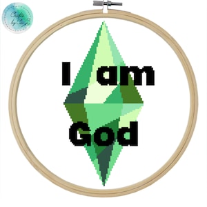May include: A wooden embroidery hoop featuring a green diamond-shaped design and the text "I am God".