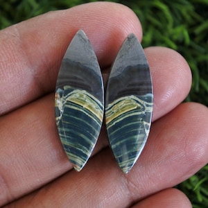 May include: A set of three ceramic mugs with a speckled, matte finish in cream, light grey, and dark grey. Each mug has a simple, minimalist design, suitable for coffee or tea.