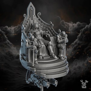 May include: A grey 3D printed miniature of a hooded figure sitting on a throne with two figures kneeling on either side. The throne is ornate and has a pointed top. The miniature is mounted on a base with a gun attached to the bottom.