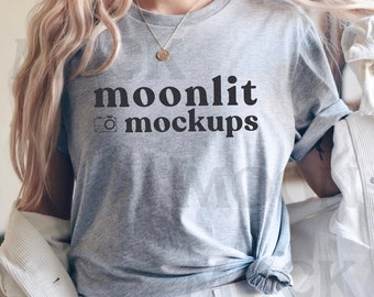 May include: A gray t-shirt with the text "moonlit mockups" and a camera icon printed on the front.