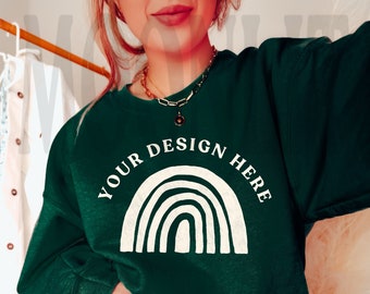 May include: A dark green sweatshirt with a white rainbow graphic and the text "YOUR DESIGN HERE".