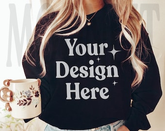 May include: A black sweatshirt with the text "Your Design Here" in white lettering. The sweatshirt has a relaxed fit and long sleeves.