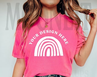 May include: A pink t-shirt with a white rainbow graphic and the text "Your Design Here".