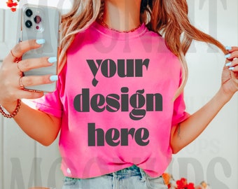 May include: A pink t-shirt with the text "your design here" printed in black.