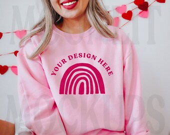 May include: Pink sweatshirt with a pink rainbow design and the text "YOUR DESIGN HERE" on the front.
