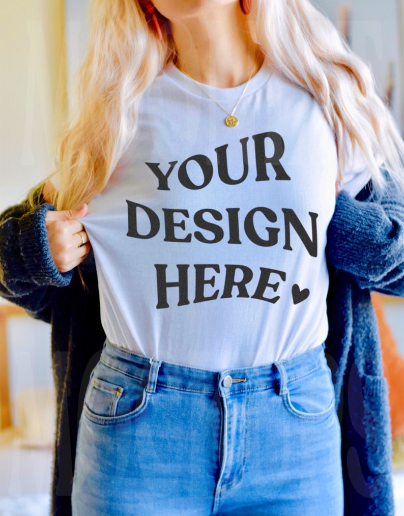 May include: A white t-shirt with the text "YOUR DESIGN HERE" in black lettering and a small heart symbol.