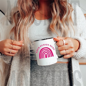 May include: White ceramic mug with a black rim and handle. The mug has a pink rainbow design and the text "YOUR DESIGN HERE".