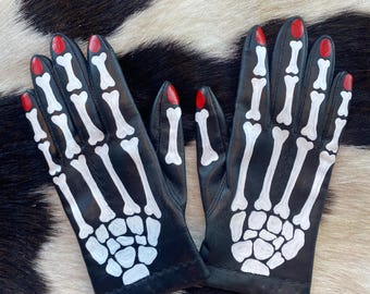 skeleton hands and red painted leather vintage gloves