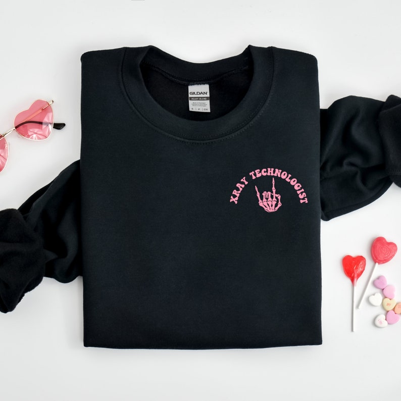 May include: Black sweatshirt with a pink graphic that says "Xray Technologist" with a skeleton hand making a rock and roll sign.