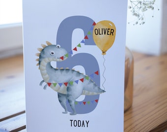 May include: A blue and gray dinosaur holding a yellow balloon with the name "Oliver" on it. The dinosaur is standing in front of a blue number six with colorful flags. The text "TODAY" is printed below the number.