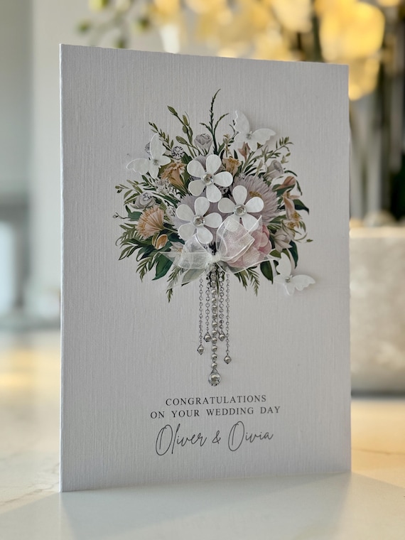 A genuinely handmade 3D paper-flower wedding card with gems and bow — a keepsake card that doubles as a tiny piece of art, not a printed flat card.
